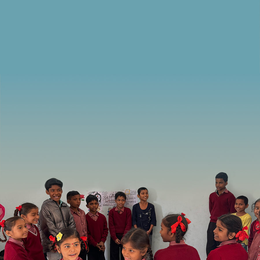 Smiling school children against blue backdrop