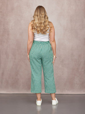 Rhianna Culotte in green gingham, back view, elasticated waist, cropped wide leg, styled with white vest and white trainers.