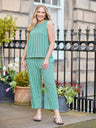Rhianna Culotte in green gingham worn with matching sleeveless top and nude sandals, styled outdoors against iron railings.