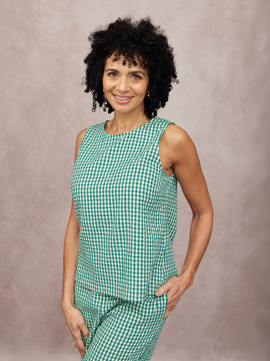 Ruby Tank Top in green gingham seersucker, worn with matching trousers, round neckline, sleeveless, on a studio background.