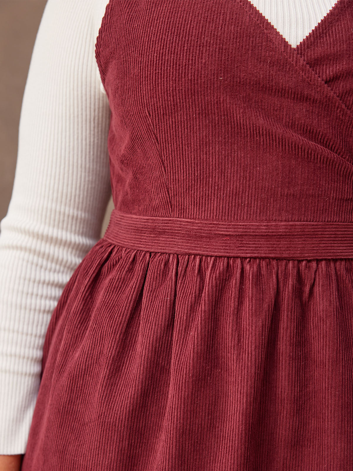 A closeup of the front of the Ally dress, showing the crossover front and the waistband detail.