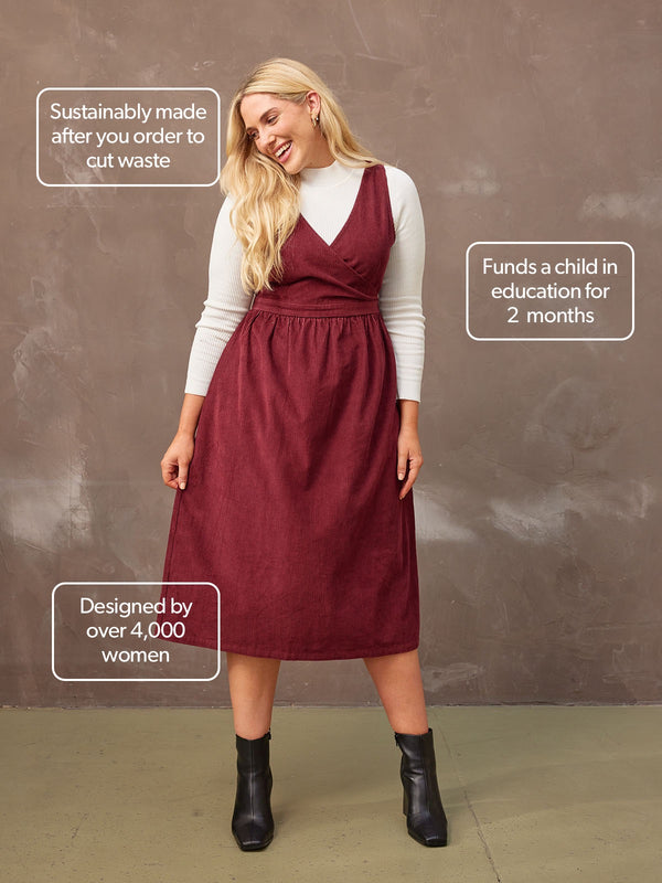 A model wears the Ally corduroy midi crossover dress in burgundy.