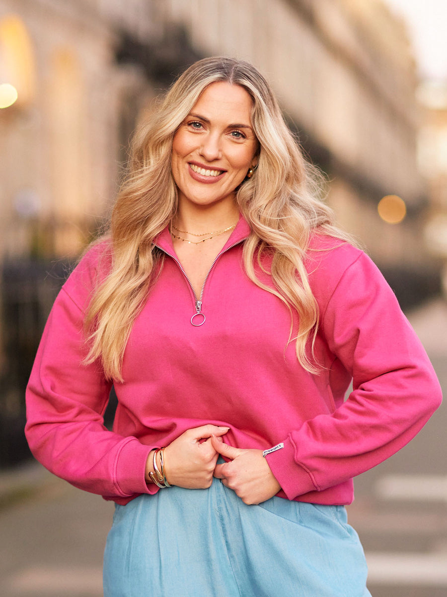 Street photo of model wearing Evie Pink sweatshirt