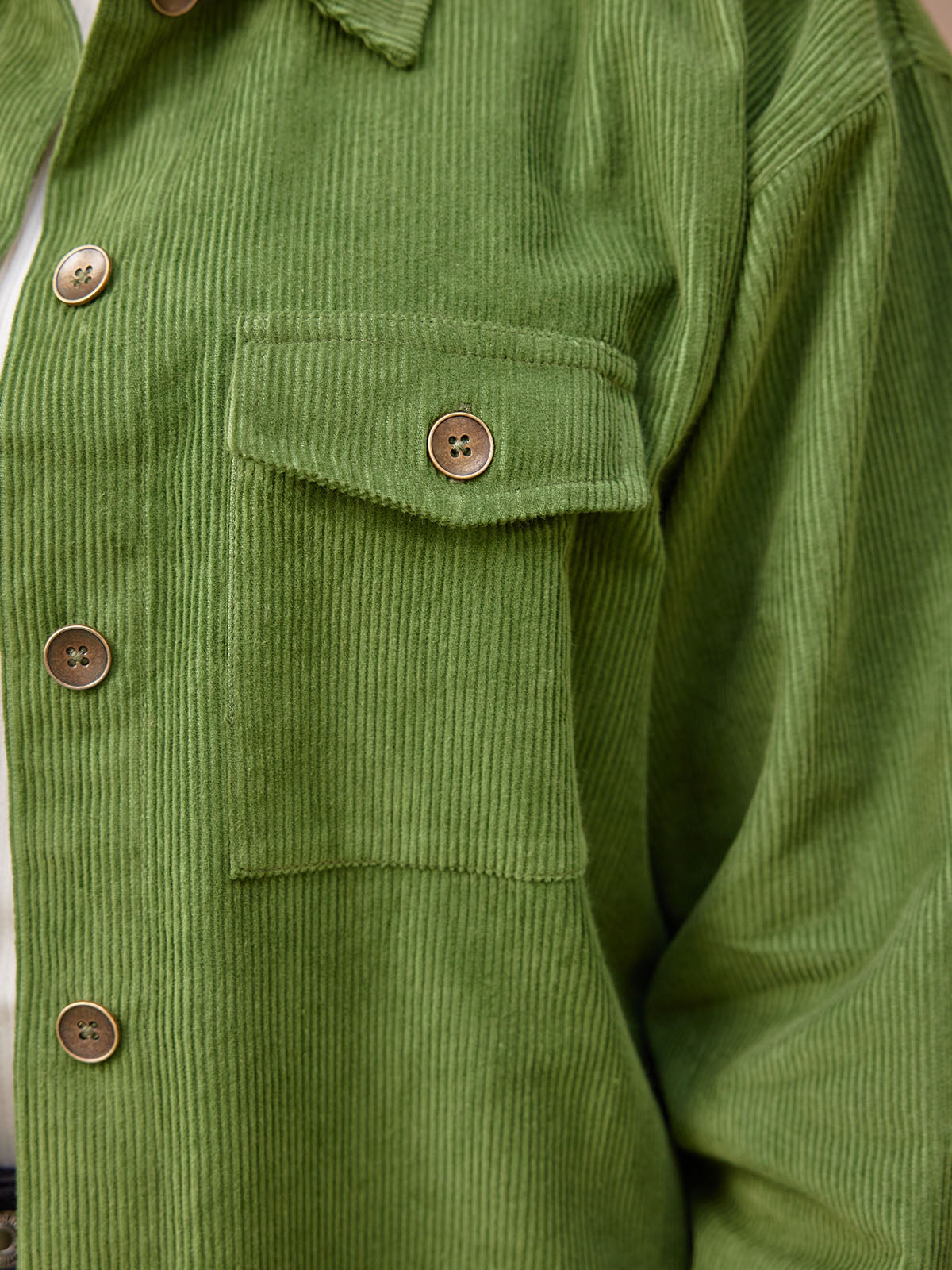 Close up detail of the sustainable Yasmynn shacket in olive, from the front showing the closure buttons and a breast pocket with a flap and one button.