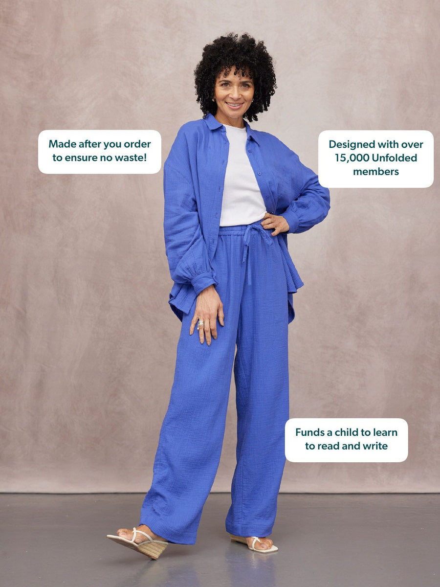 Joy Cotton Crinkle Trouser in cobalt blue wide-leg fit, worn with matching shirt and white tee by a smiling woman.