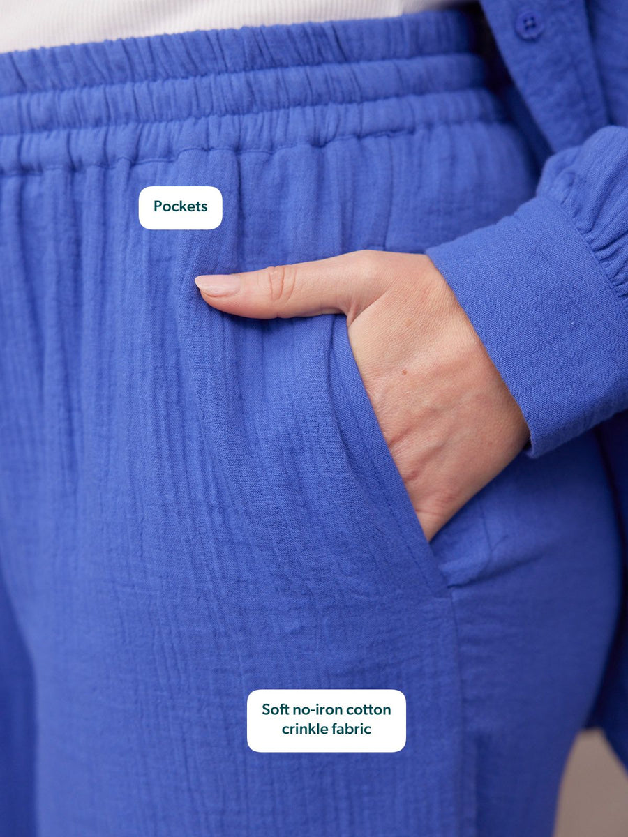 Joy Cotton Crinkle Trouser in cobalt blue, close-up of elastic waist and side pocket with hand tucked in.