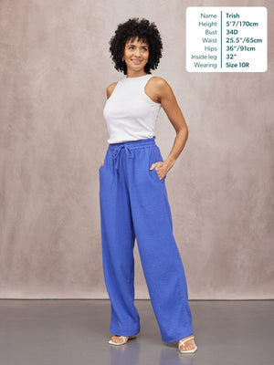 Joy Cotton Crinkle Trouser in cobalt blue with drawstring waist, worn with white sleeveless top and sandals