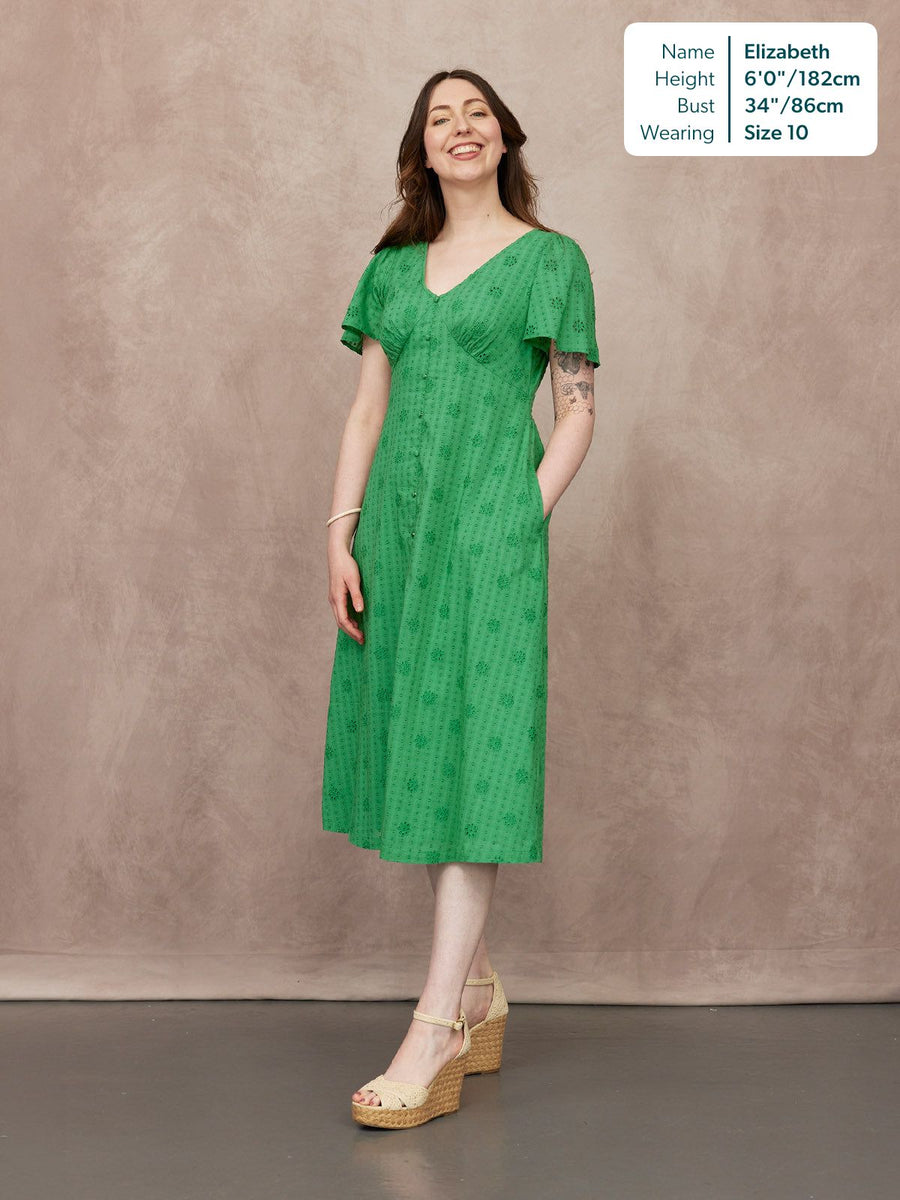 Allegra Broderie Dress in green, flutter sleeves, V-neck, button front, midi length, worn with wedge sandals