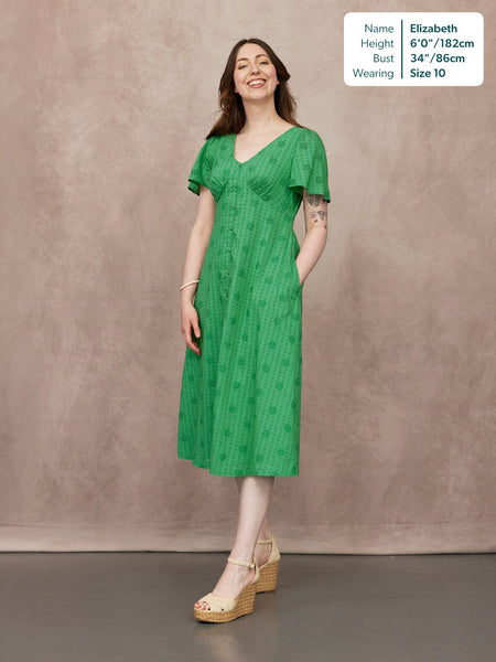 Allegra Broderie Dress in green, flutter sleeves, V-neck, button front, midi length, worn with wedge sandals
