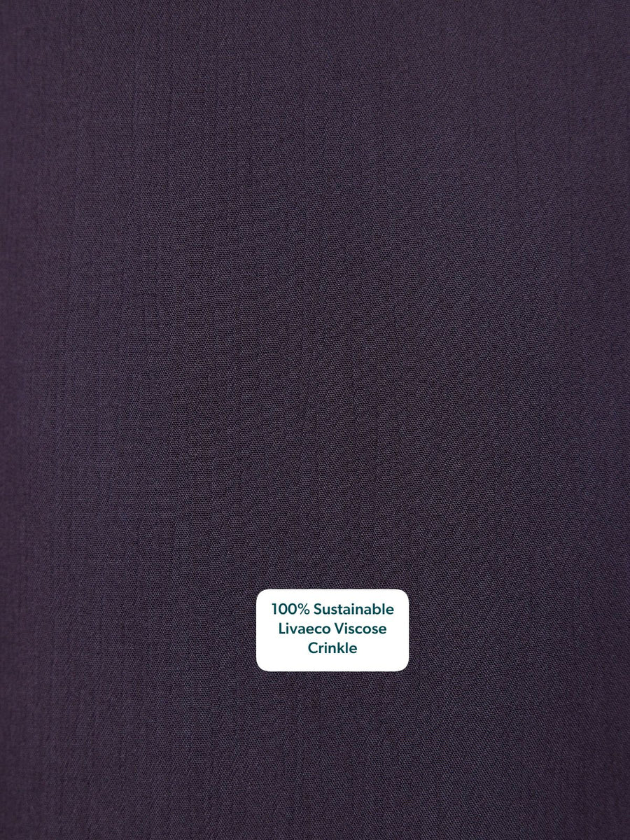 Close-up of deep purple crinkle fabric texture with a subtle woven finish.