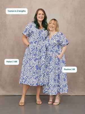 Two models wearing white and blue botanical print v-neck midi dresses with short sleeves, shown in two lengths.