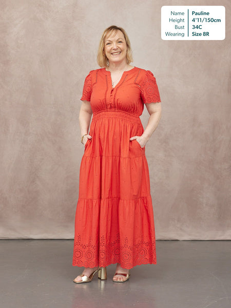 Georgie Cotton Summer Dress in red, featuring broderie anglaise sleeves, smocked waist, tiered maxi skirt.