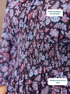 Close-up of a dark navy floral dress with blue and red blooms, featuring a shirred elastic waist and three-quarter sleeves.