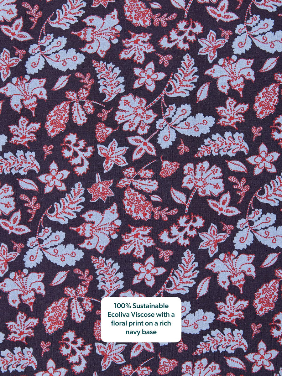 Close-up of a navy fabric with an all-over floral print in pale blue and red.