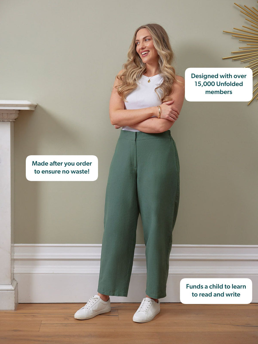 Myrtle Barrel Leg Trouser in green, high-waisted wide leg, styled with white tank and sneakers, worn by smiling model