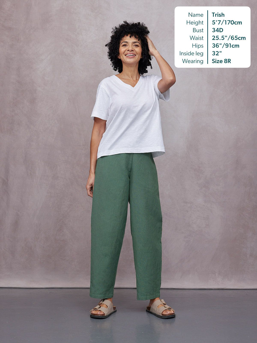 Myrtle Barrel Leg Trouser in green, worn by a model with a white V-neck tee and sandals, full-length front view