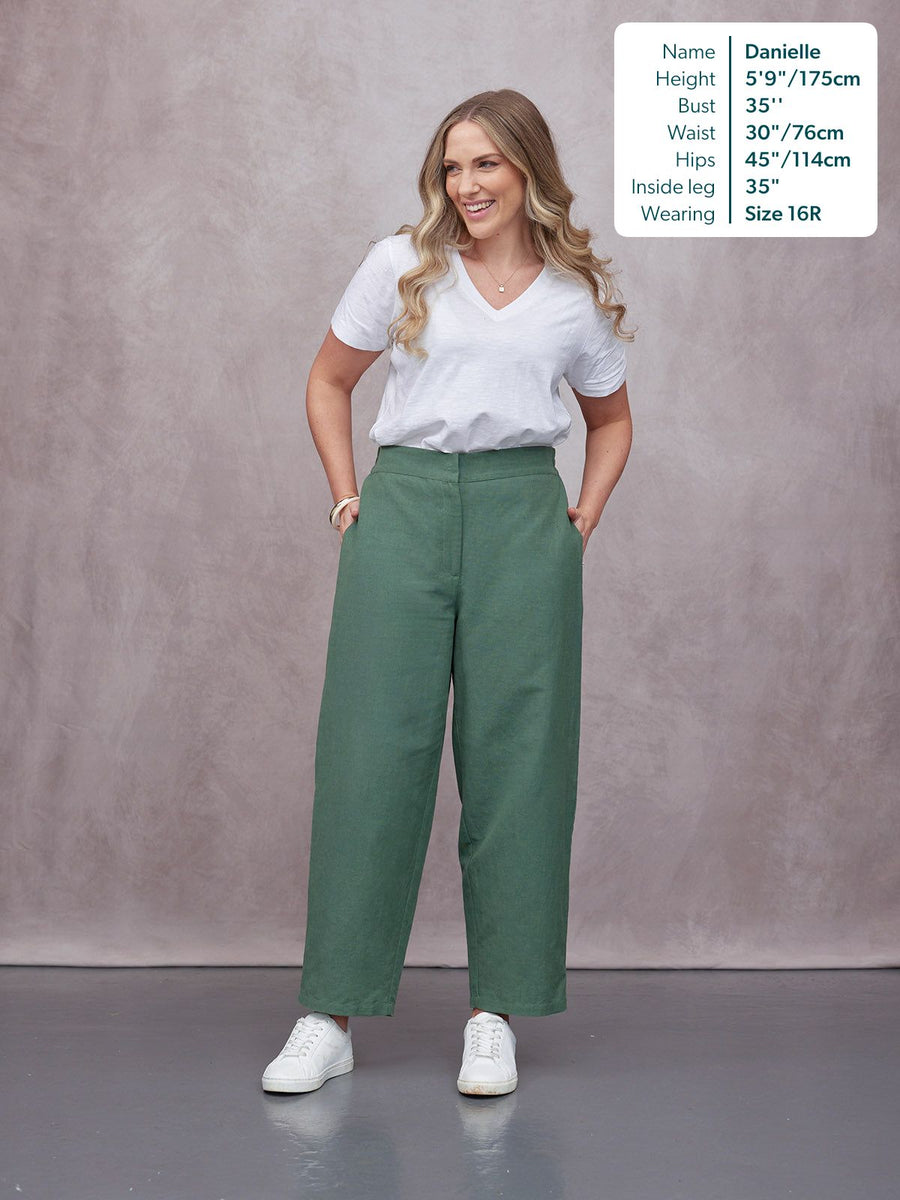 Myrtle Barrel Leg Trouser in green, high-waist wide-leg fit, styled with white tee and sneakers, worn by smiling model