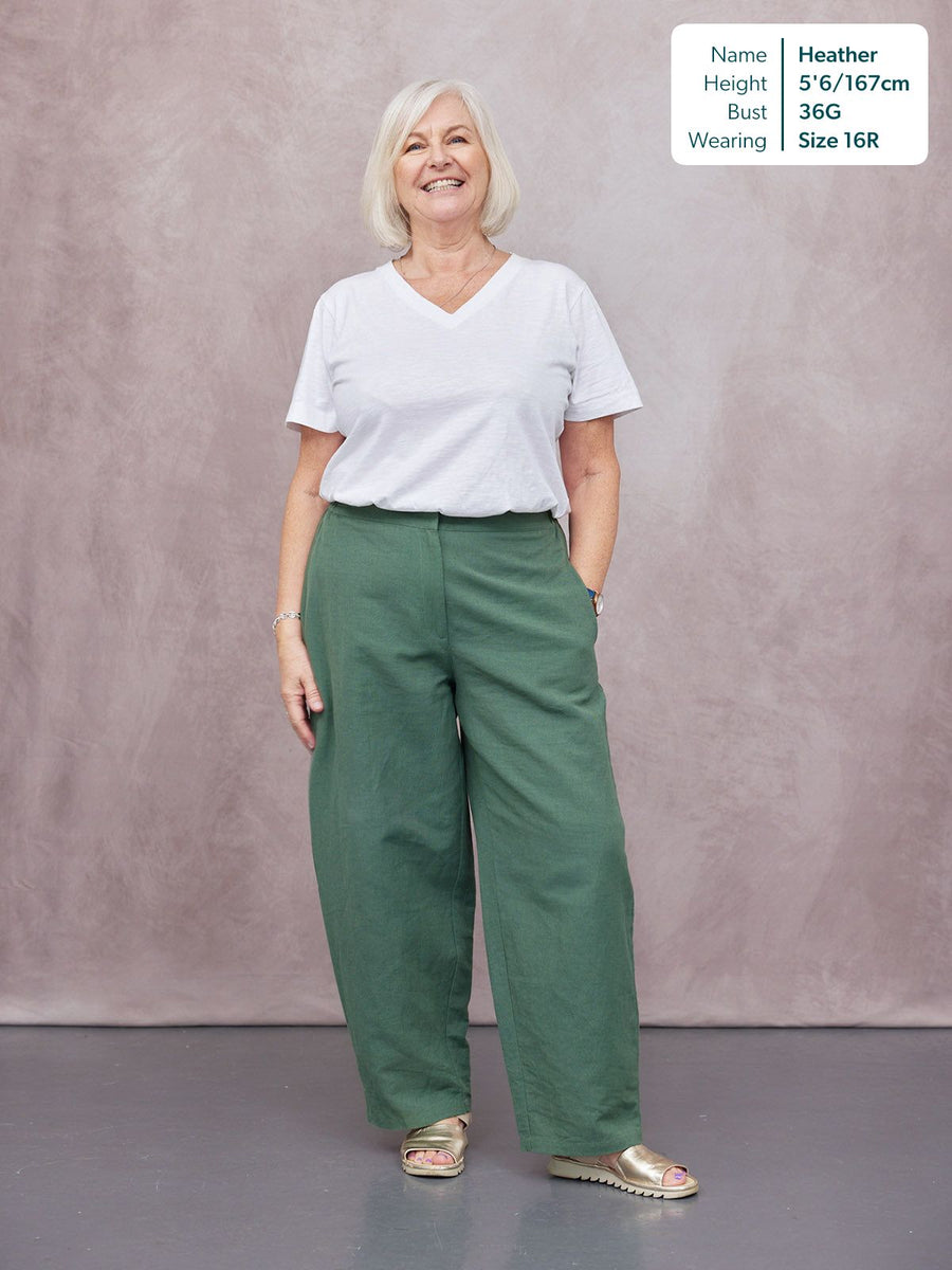 Myrtle Barrel Leg Trouser in green, worn by a woman with white V-neck tee and gold sandals, full-length studio shot