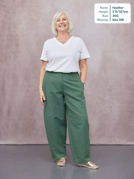 Myrtle Barrel Leg Trouser in green, worn by a woman with white V-neck tee and gold sandals, full-length studio shot