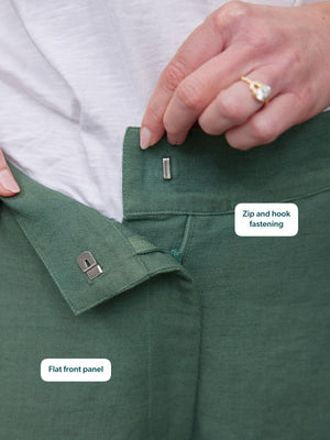 Myrtle Barrel Leg Trouser in green, close-up of flat front panel with silver zip and hook fastening detail