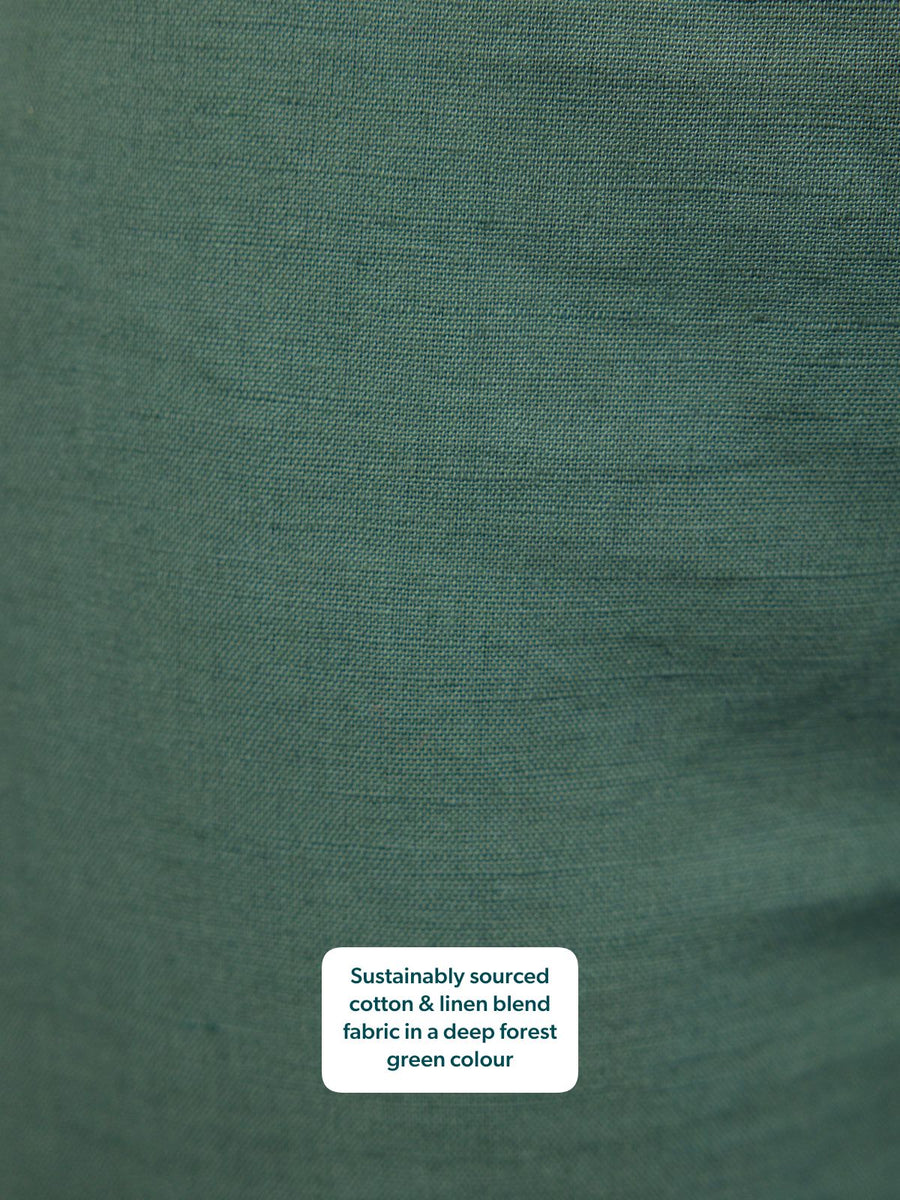 Close-up of Myrtle Barrel Leg Trouser fabric in deep forest green sustainably sourced cotton-linen blend