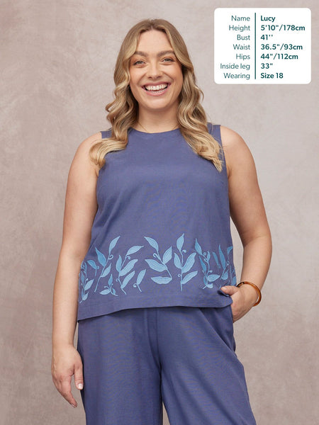 Co-Ord Embroidered Top & Trouser Bundle in blue, with leaf embroidery hem, worn by smiling model Lucy, size 18