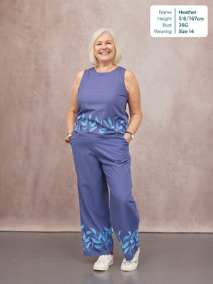 Co-Ord Embroidered Top & Trouser Bundle in blue, featuring floral leaf print hem detail, worn by a smiling model