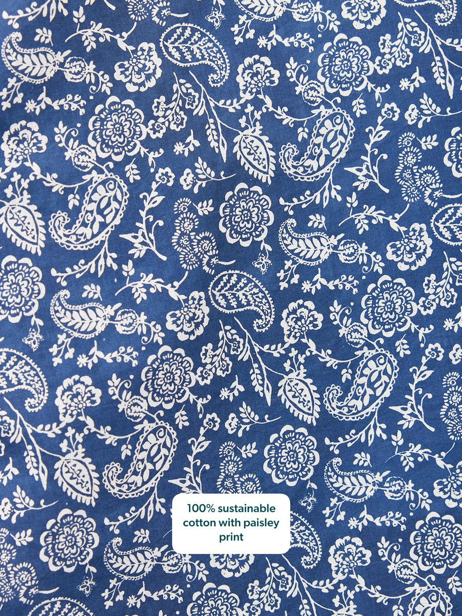 Close-up of navy blue cotton fabric with an allover white paisley and floral print.