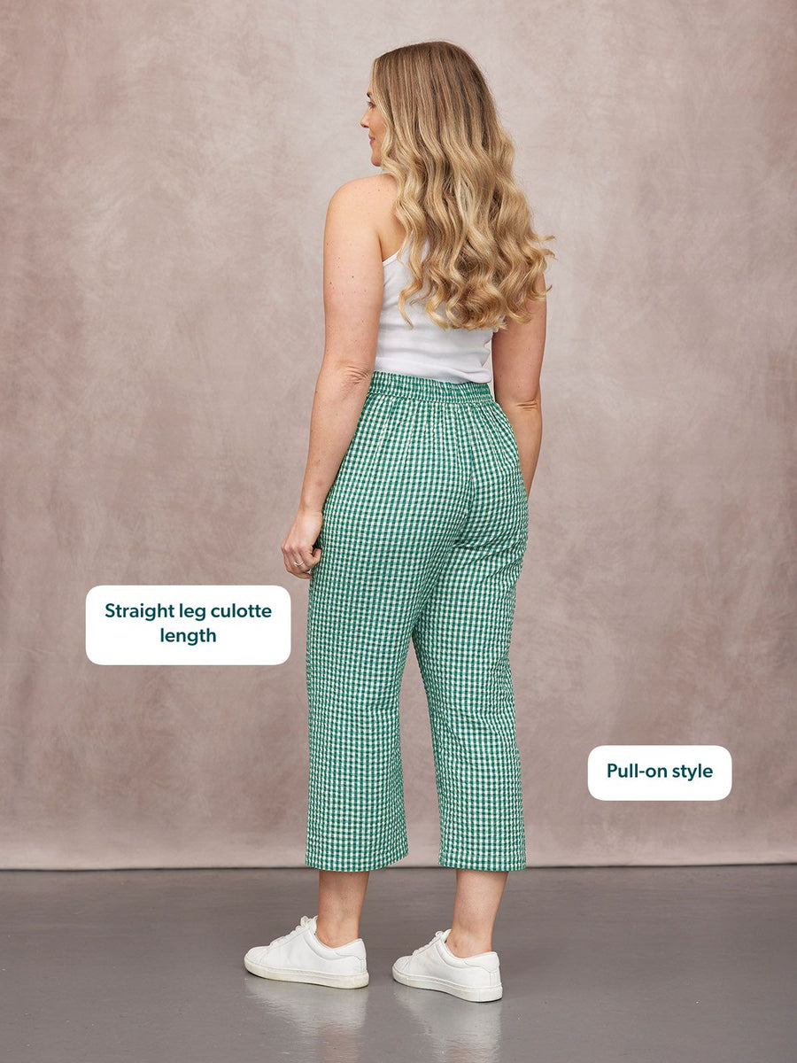 Rhianna Culotte in green gingham, straight-leg pull-on style, worn from behind with a white vest and white trainers.