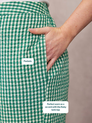 Rhianna Culotte in green gingham seersucker, close-up of side pocket with hand tucked in, paired with white tank top.