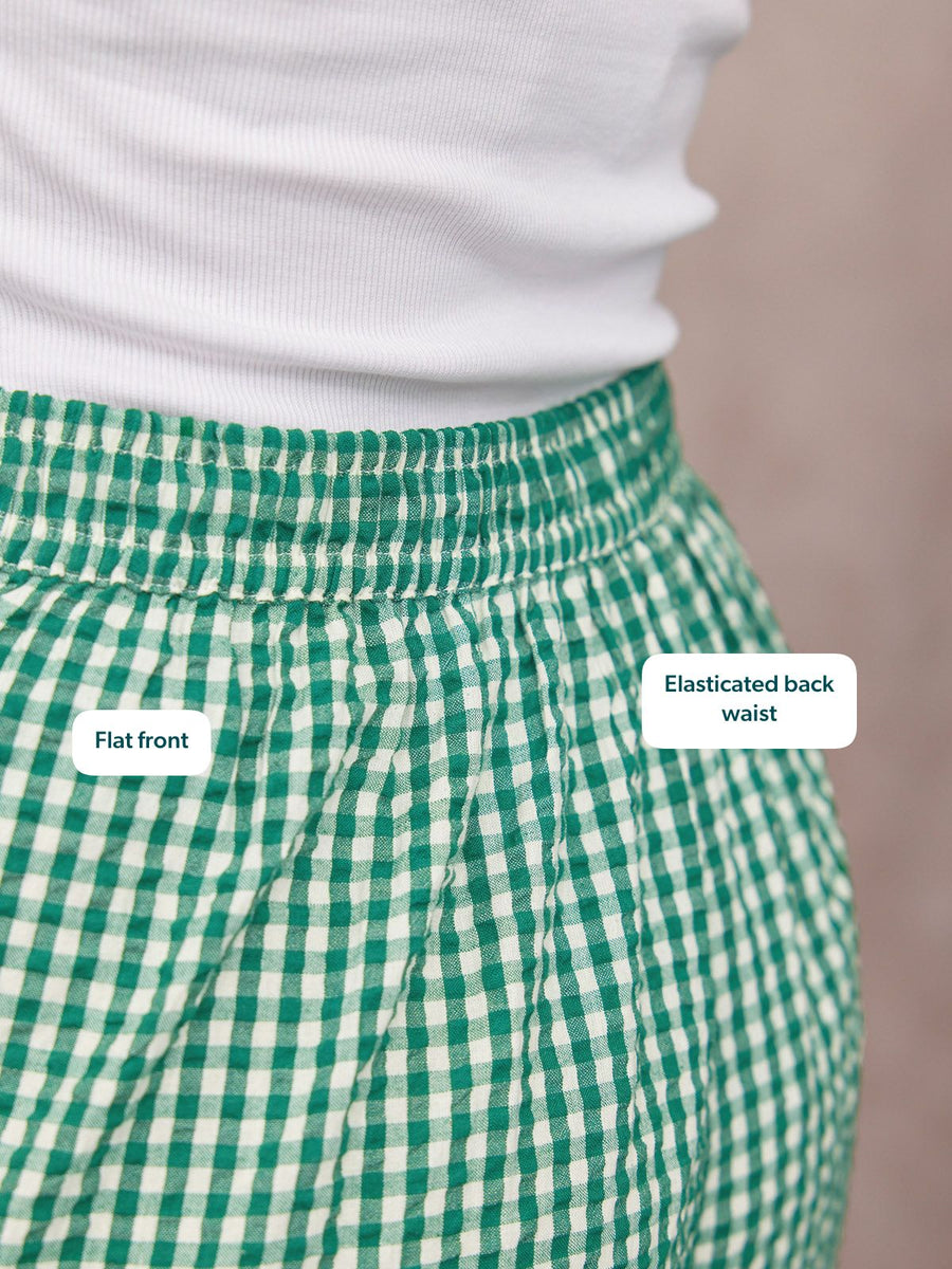 Rhianna Culotte in green gingham, close-up of flat front and elasticated back waist, paired with a white top.