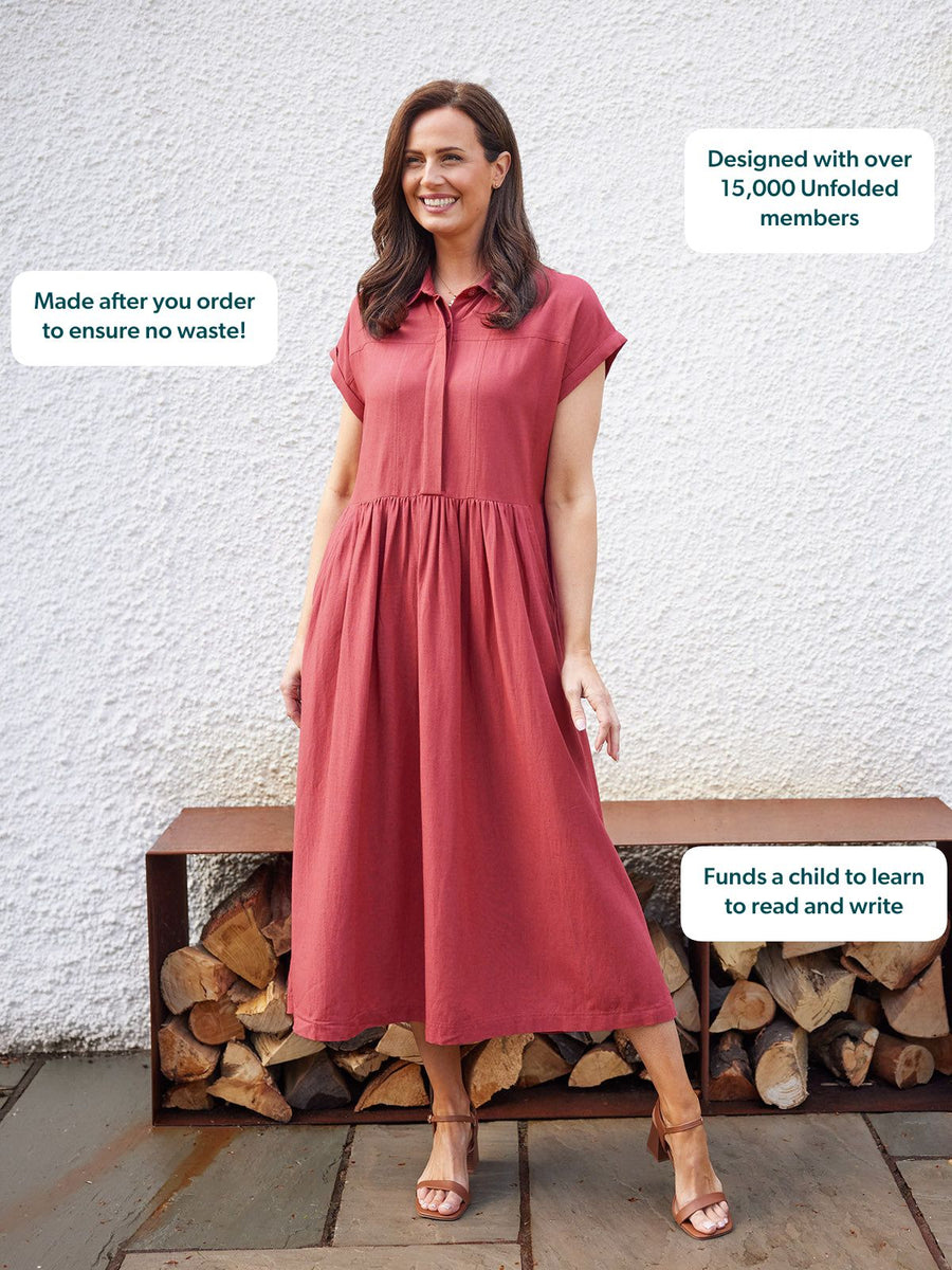 Model wearing a dusty rose midi shirt dress with a gathered skirt and cap sleeves, paired with tan block-heel sandals.