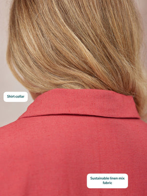 Close-up back view of a model wearing a coral red linen-mix shirt, highlighting the shirt collar detail.