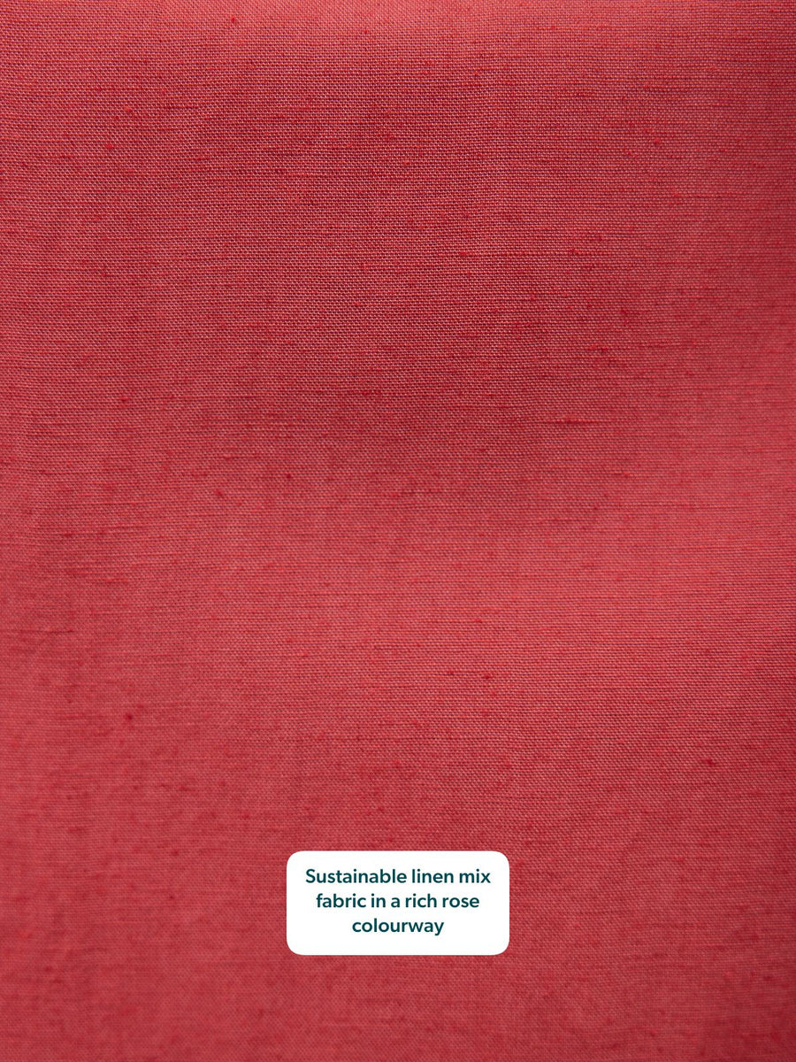 Close-up of a rich rose linen-mix fabric with a natural slubbed texture.