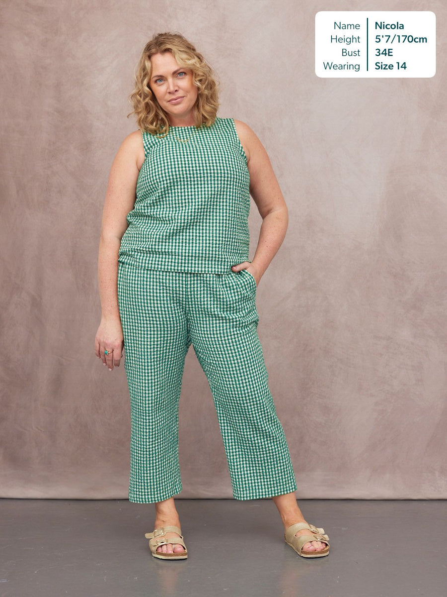 Ruby Tank Top in green gingham, worn as a co-ord set with matching trousers and tan sandals, modelled front-on by Nicola.