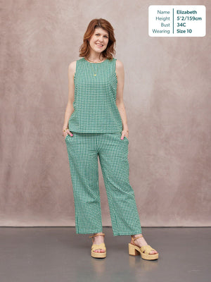 Ruby Tank Top in green gingham worn by a model with matching trousers and platform sandals, studio background