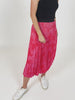A video of a model turning round and displaying the Gill skirt in red and pink smudge print. The movement is causing the skirt to swish.