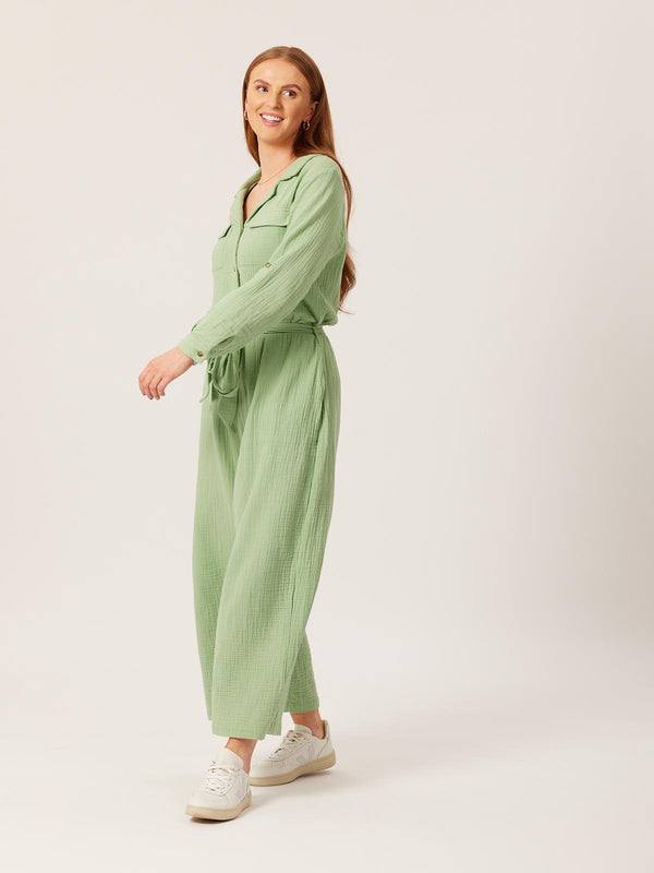 A model wears the Clara jumpsuit and looks off to the side, pictured against a white backdrop.