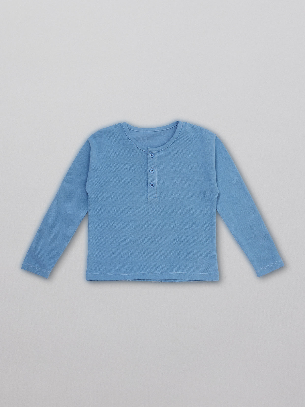 Sustainable kids pique t-shirt in blue with buttons, pictured from the front.