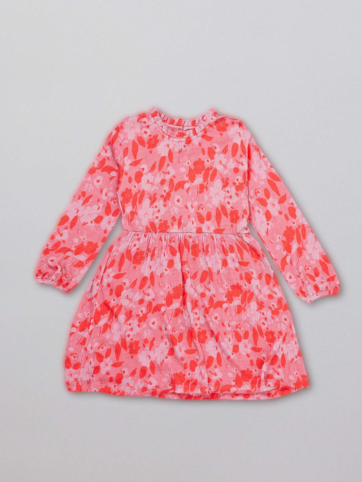 Eco-friendly kids smock dress in pink, pictured from the front.