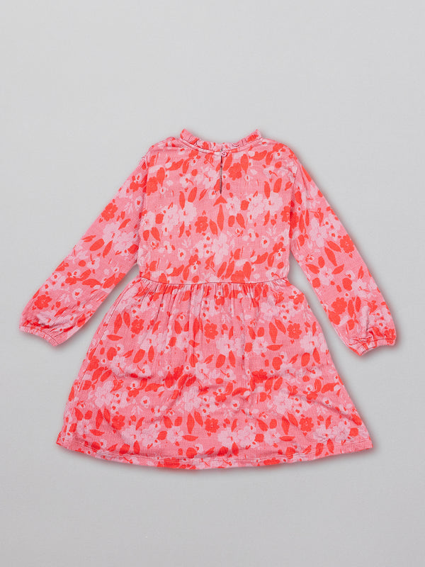 Eco-friendly kids smock dress in pink, pictured from the back. 