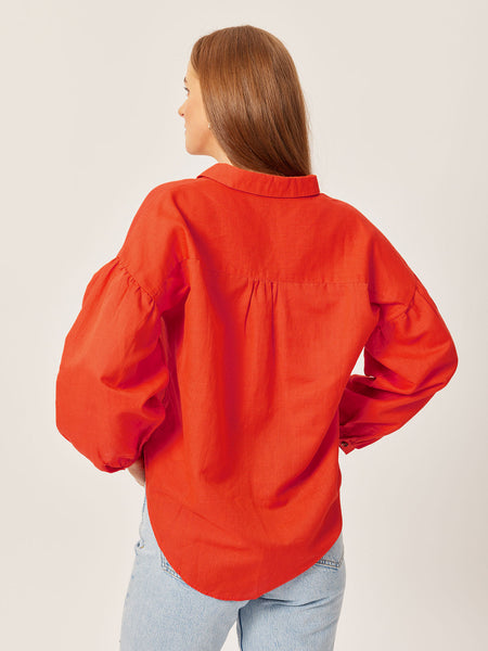 A model is pictured from behind wearing the sustainable Martha shirt, with their hair pulled to one side. 