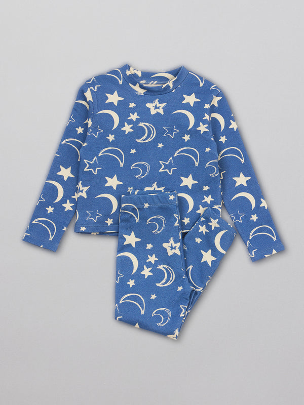 A pair of sustainable kids pyjamas in blue with a white moon and star print.