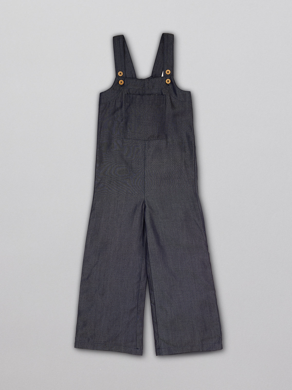 Sustainable dungarees for kids  with a large front pocket and adjustable straps, pictured from the front.