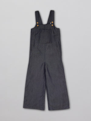 Sustainable dungarees for kids  with a large front pocket and adjustable straps, pictured from the front.