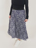 A video of a model wearing the sustainable Gill skirt in navy abstract leaf print, turning around and swishing the skirt.